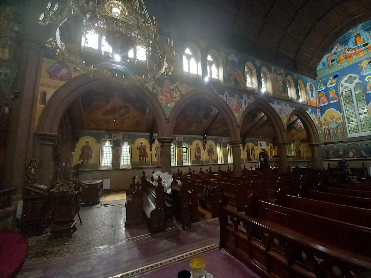 Church interior before — poor, dim lighting letting down the murals